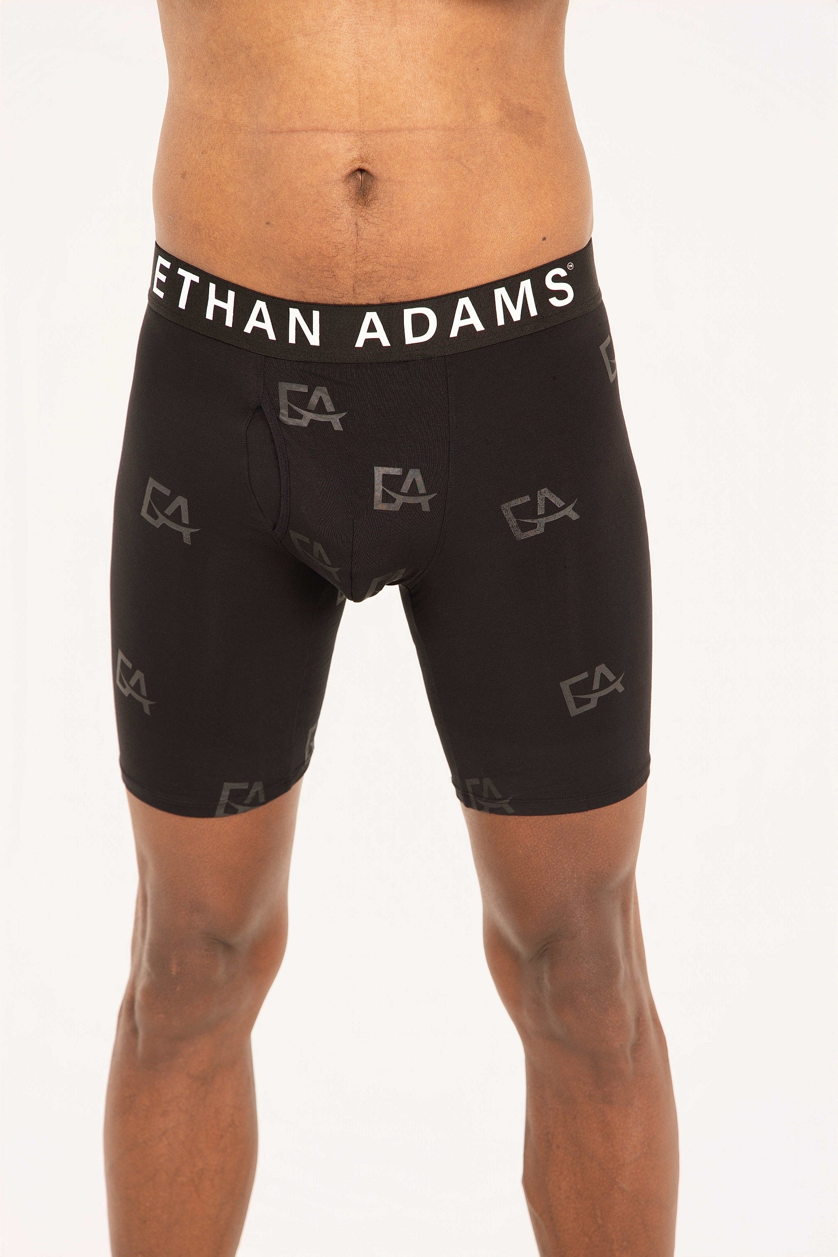 Black athletic shorts with 'Ethan Adams' branding on a white background