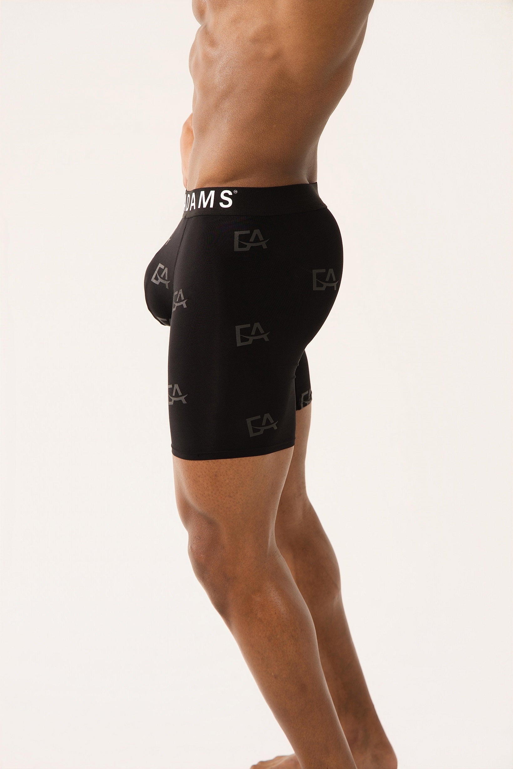 Black athletic shorts with brand logo on a white background